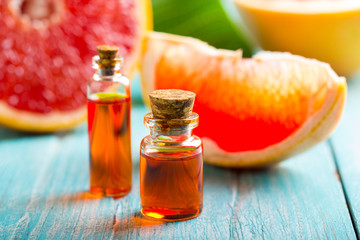 citrus oil cosmetic grapefruit medicine health nature glass vial wooden background
