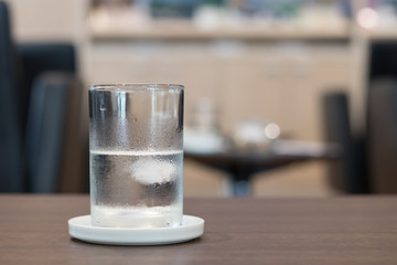 Transparent glass of fresh drinking water with cold water drop