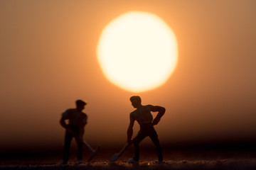 Fototapeta na wymiar Abstract,silhouette Model people mining on sky sunset background.