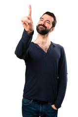 Fototapeta premium Handsome man with beard touching on transparent screen