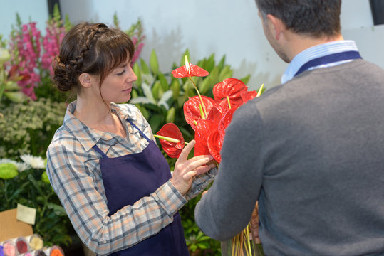 male and female florists working in greenhouse
