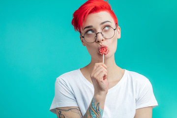 dreaming romantic girl with candy. glamour pretty girl is having a sweet tooth. copy space
