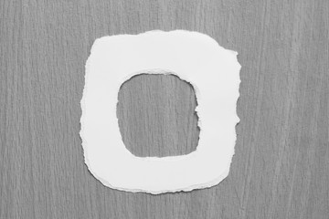 alphabet letters recycled torn paper craft on gray background (O)