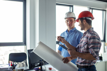 positive leader in casual outfit of the team giving tasks to the worker. side view photo. copyspace