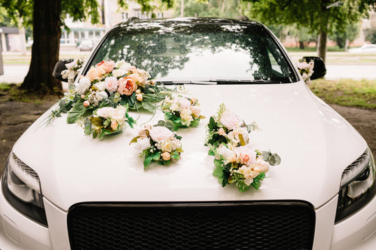 Beautiful wedding car. Front of the luxury car decorated flowers