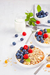 Homemade granola or oatmeal muesli with nuts, dried fruits and fresh berries. Healty diet breakfast, vegeterian food concept