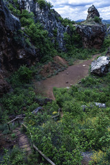Obraz premium From above small path with wooden steps in mountains covered with green in Cerro del Hierro, Seviile