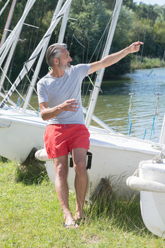 mature sailing professor giving lesson