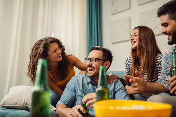 Portrait of group of friends having fun at home and enjoying together
