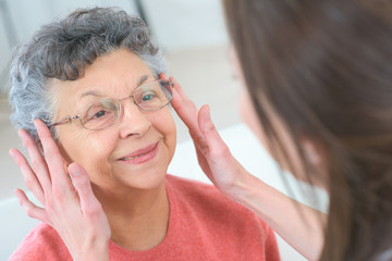 elderly woman fitting the eyeglasses