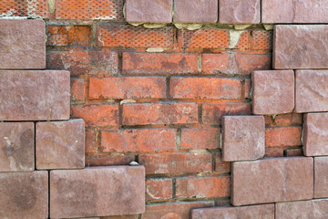 Broken facade of the building, marriage in the work of builders. Poor-quality cement caused by the fall off of the facing tiles on the facade.