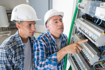 electrician showing the inside of electrical panel board
