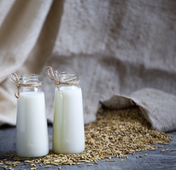 Oatmeal in bottles and oats in a bag