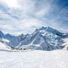 Fototapeta na wymiar Ski slope, Peak Ine and Mt. Sofrudzhu in winter sunny day. Dombay ski resort, Western Caucasus, Russia.