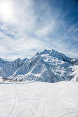 Fototapeta na wymiar Ski slope, Peak Ine and Mt. Sofrudzhu in winter sunny day. Dombay ski resort, Western Caucasus, Russia.