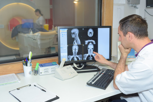 specialist checking brain tomography results