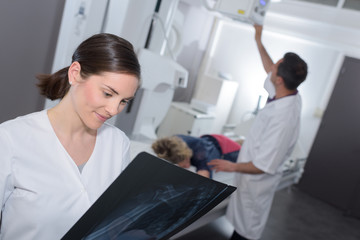woman doctor looking at x-ray radiography in clinic