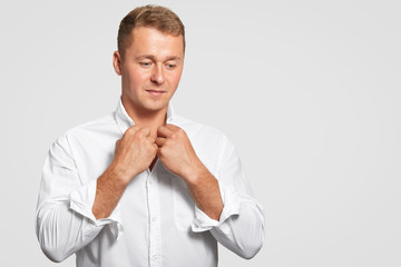 Thoughtful determined businessman in elegant formal white shirt, thinks about something, focused...