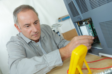 engineer measuring multimeter panel board