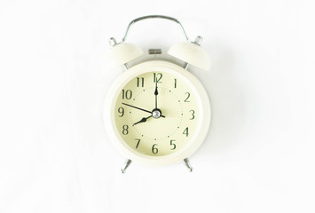 Closeup top view alarm clock on white bed in bedroom for wake up time concept
