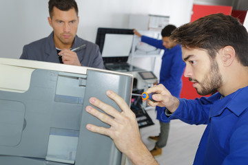 Technician unscrewing appliance