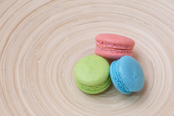 colorful macaroons in wood plate