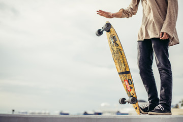 Close up of man foots riding longboard in park © alfa27