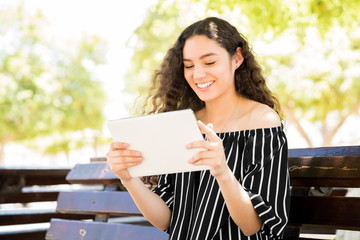 Fototapeta premium Happy girl reading with e-reader