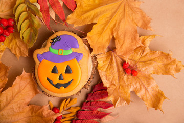 Halloween holiday - traditional sweets. Gingerbread pumpkin with a smile on the background of...