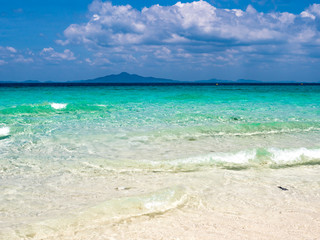 emerald ocean and cloudy sky