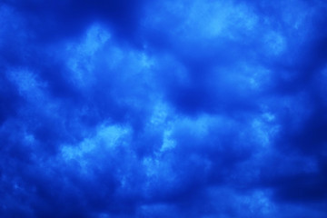Dark storm clouds in the sky.  The sun comes out of the clouds. Dramatic background. Stormy weather.