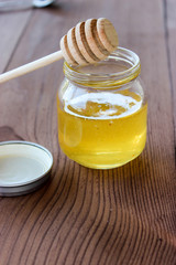 A jar of honey on the table.