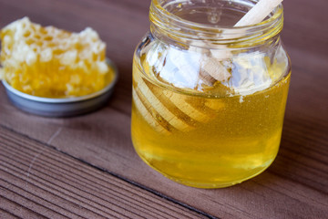 A jar of honey on the table.