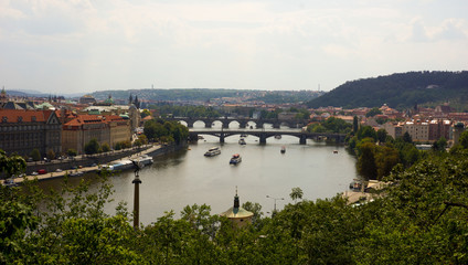 Fototapeta na wymiar Panoramic view on Prague and Vltava with bridges and boats, Czech Republic