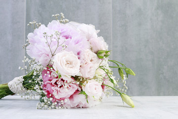 Bouquet with pink peonies, roses and yellow eustomas (lisianthus)