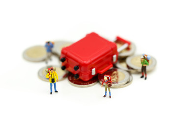 Miniature concept : Group of young traveler traveling / standing on coin Currency of the world,business trip traveler concept.
