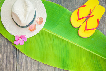 Palm leaf Straw hat Pink sunglasses Beach flip-flops Summer background