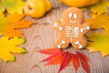 Gingerbread man skeleton on a pumpkin background. Halloween food concept.