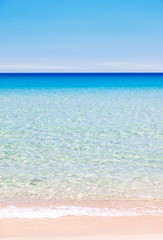 Calm ocean background with multicolored layers of beach sand, sea and sky, vertical orientation 