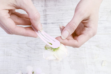 Woman shows how to make beautiful wedding hair clips for bridesmaids, tutorial.