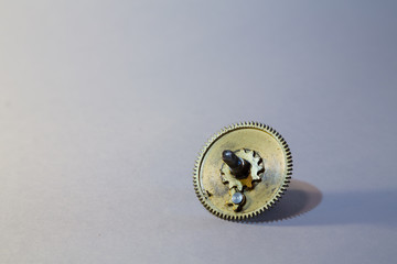 Yellow metal gear on white background