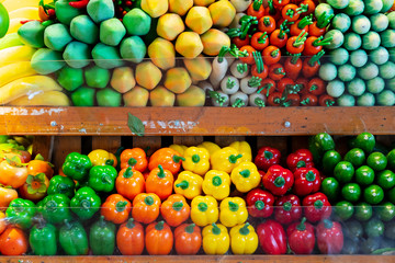 Background of multi colored assortment artificial fruits and vegetables.