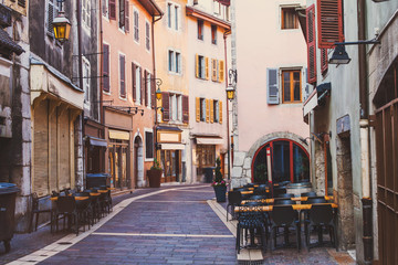 Annecy old town, historical buildings in city center, landmark architecture, cozy street in France with cobblestone pavement and sidewalk restaurants