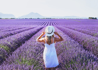 dream and inspiration, summer happy woman in romantic white dress enjoying nature in lavender flowers fields