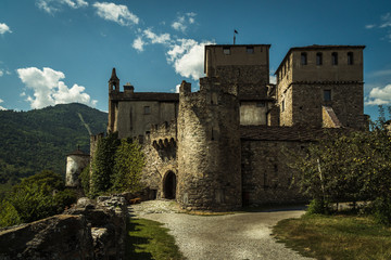 Fototapeta na wymiar old stone castle medieval city of aosta italian alps cloudy sky