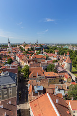 Obraz premium Churches, city walls, towers and other old buildings at the Old Town in Tallinn, Estonia, viewed from above on a sunny day in the summer.