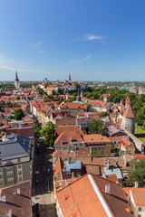 Naklejka na ściany i meble Churches, city walls, towers and other old buildings at the Old Town in Tallinn, Estonia, viewed from above on a sunny day in the summer.