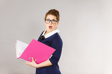 Shocked business woman looking at documents