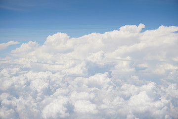 Clouds and sky as seen through window of an aircraft