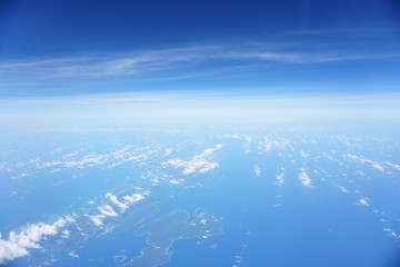 Clouds and sky as seen through window of an aircraft